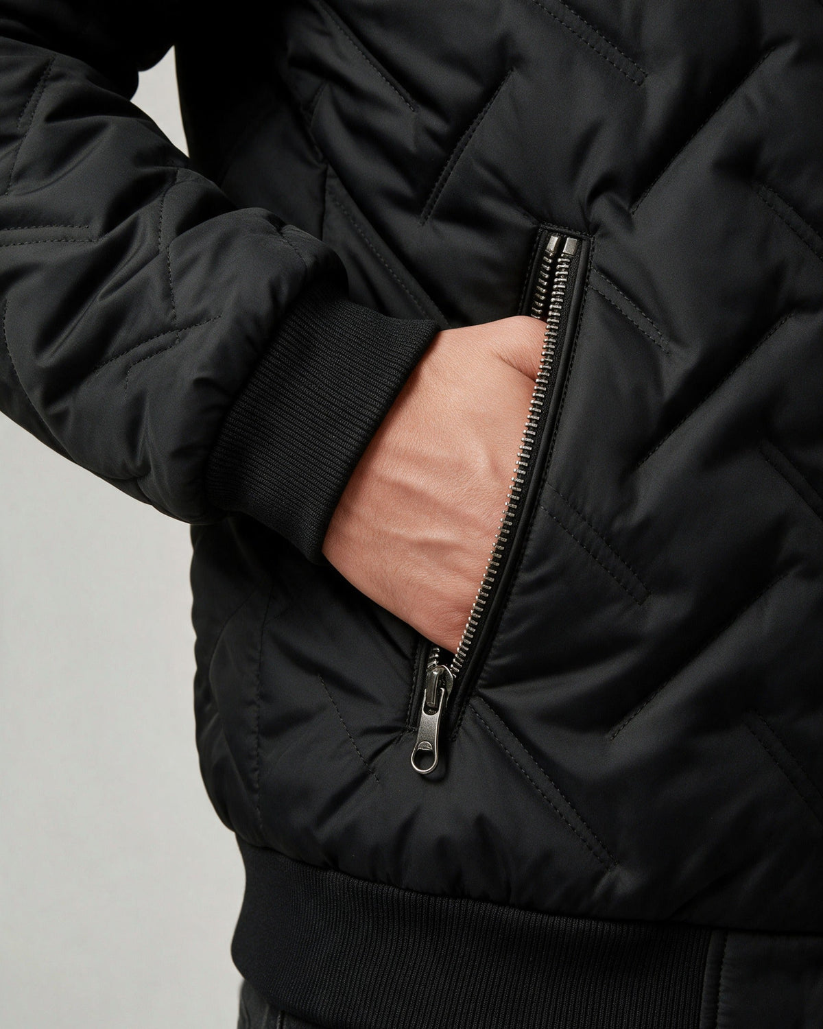 Close-up of the zipped side pocket and ribbed cuff