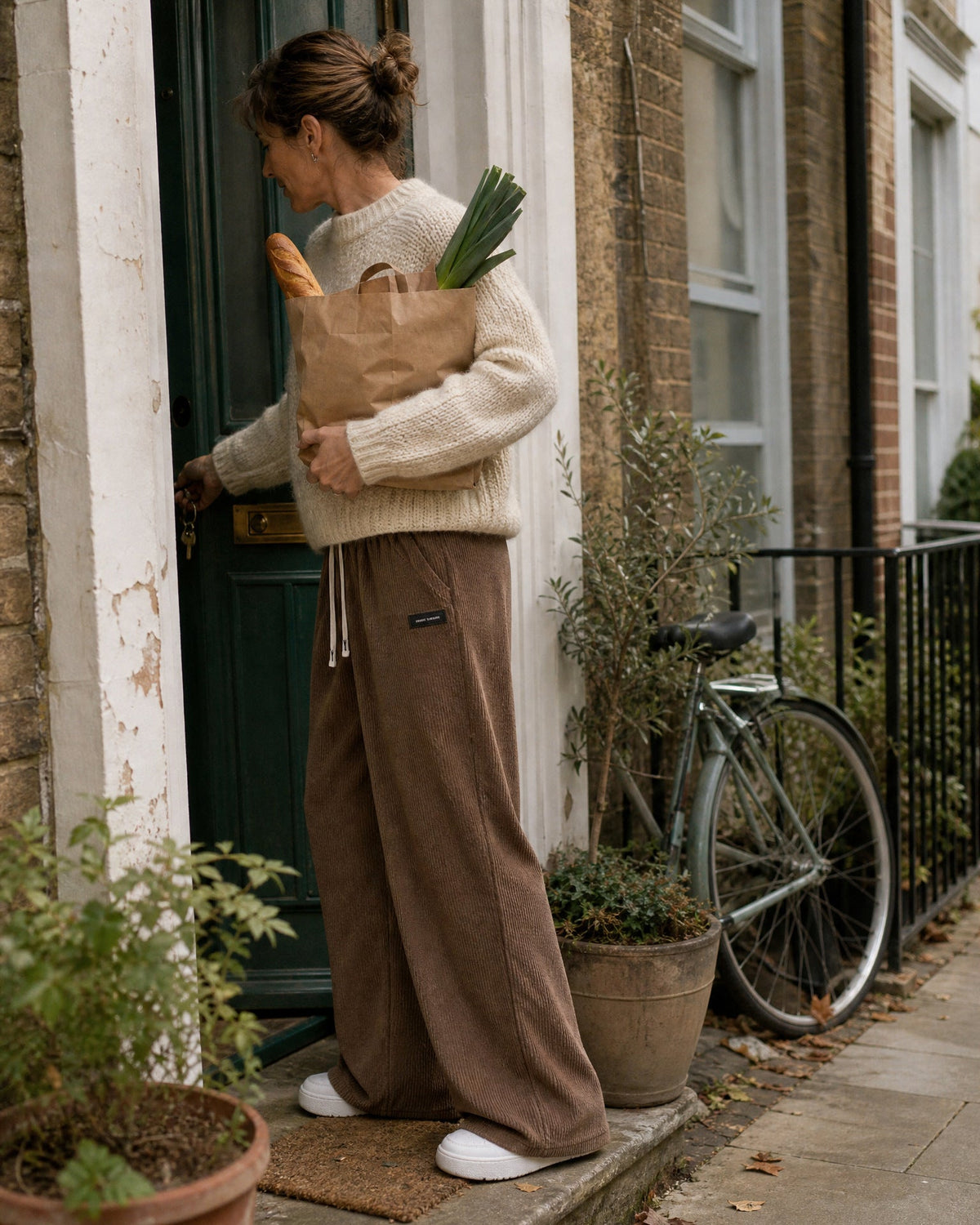 Tilbury wide-leg corduroy pants in Dark Brown, arriving home with the shopping